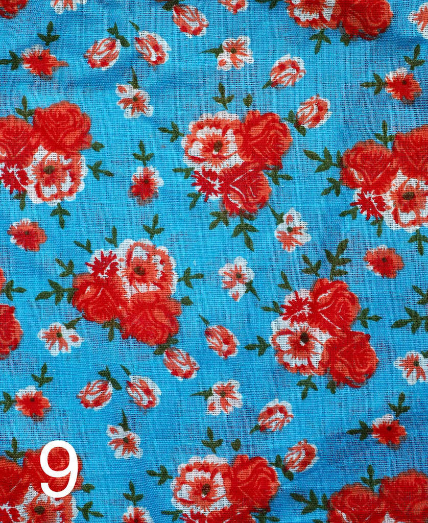 red flowers in a bouquet on blue fabric for little koko not-for-profit gift bags