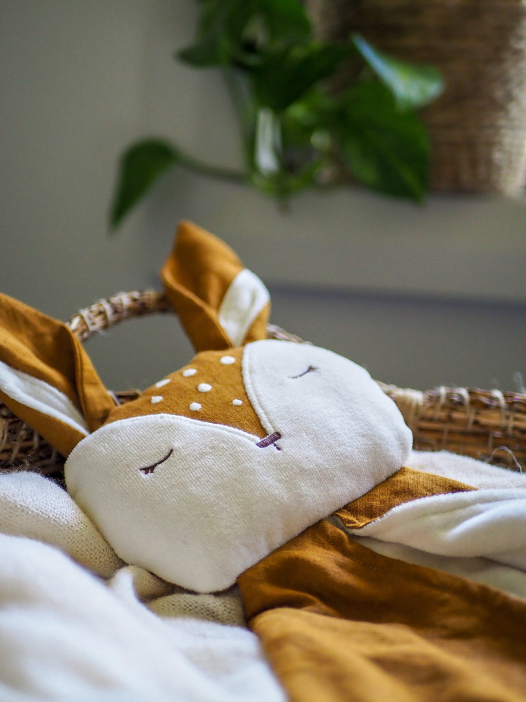 little koko deer comforter in a handwoven basket 