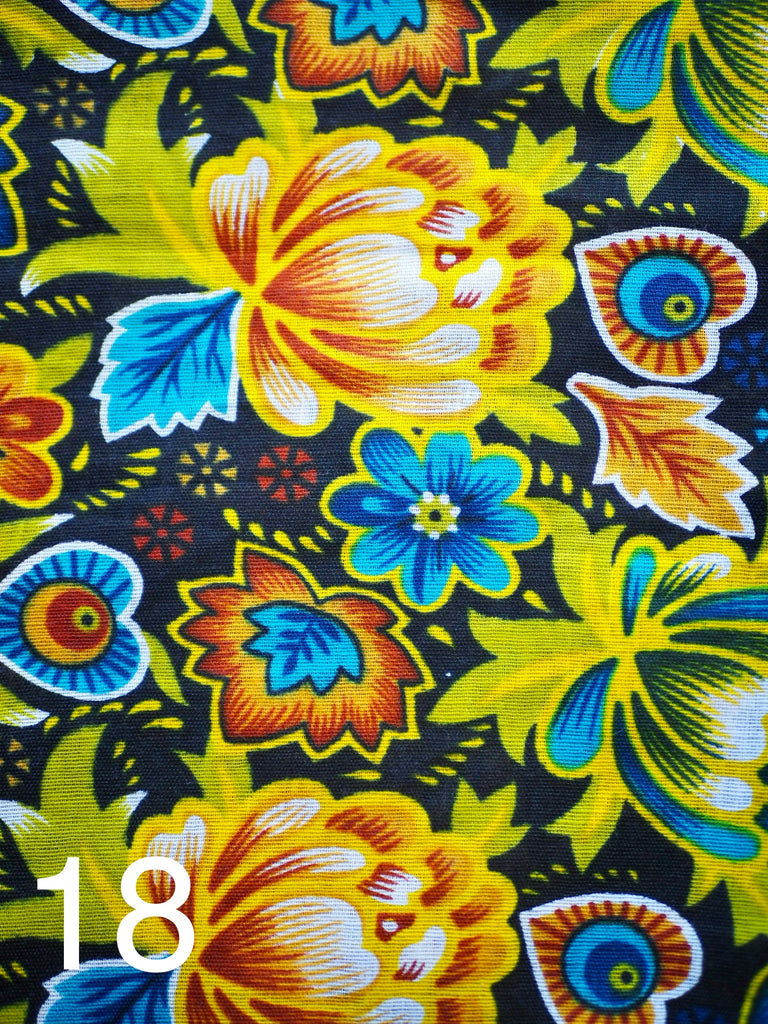 a tropical flower design with orange and blue florals on black fabric for little koko not-for-profit gift bags