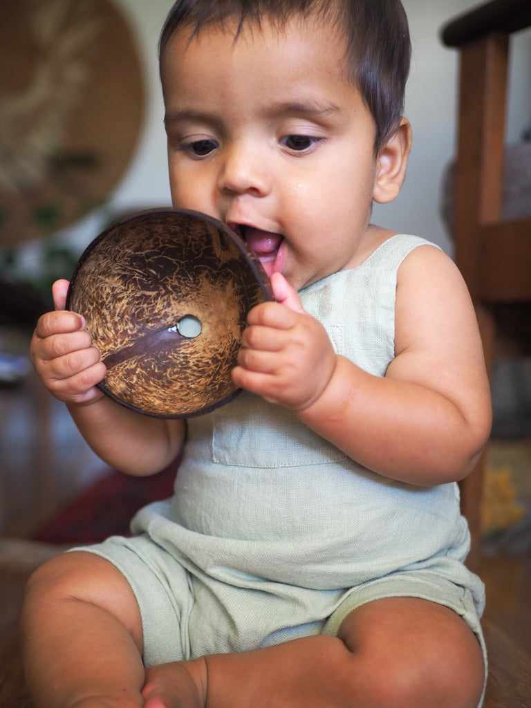happy baby playing with little koko bath time coconut shells
